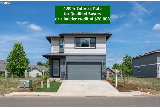 A modern two-story home with a gray facade, double garage, and a sign offering a 4.99% interest rate or $20,000 builder credit.